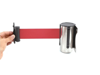 Barrier cartridge with extended red tape attached to wall bracket
