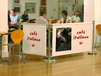 Barrier with an informative advertising poster to enclose the territory of the cafe