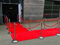 The red carpet is fenced with barrier posts. Road to the event.