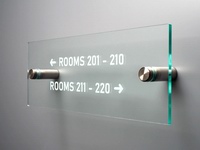 Room numbering indicator on the glass, attached to the wall with two screws